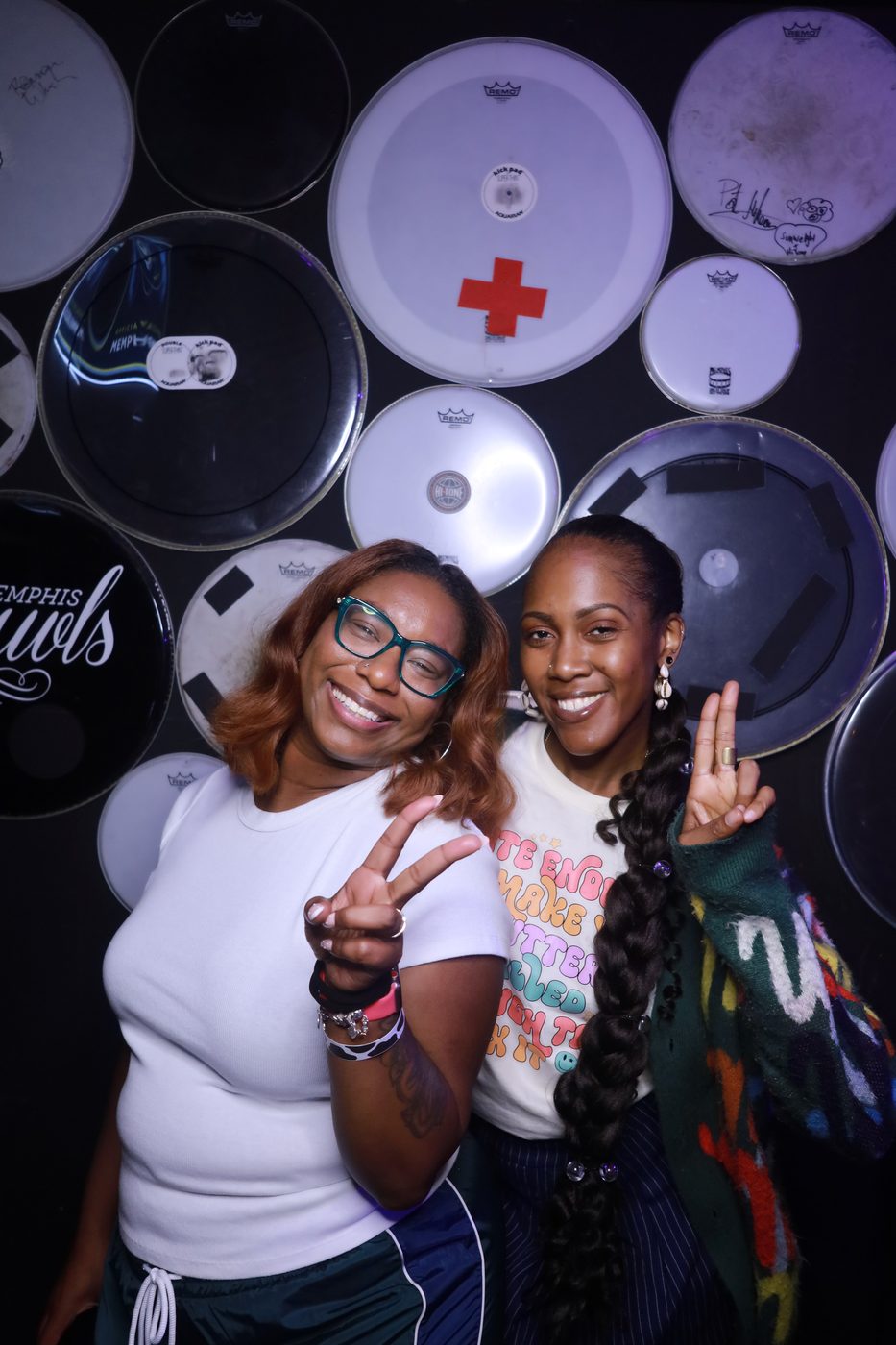 Friends throwing peace signs at a Memphis venue photo booth